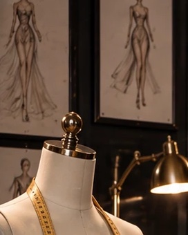 Fashion sketches above a dress form