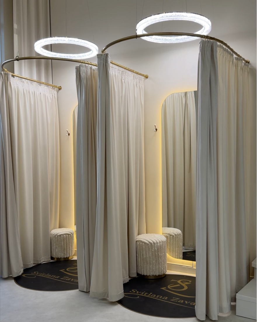 Fitting rooms with ring lights and cream curtains