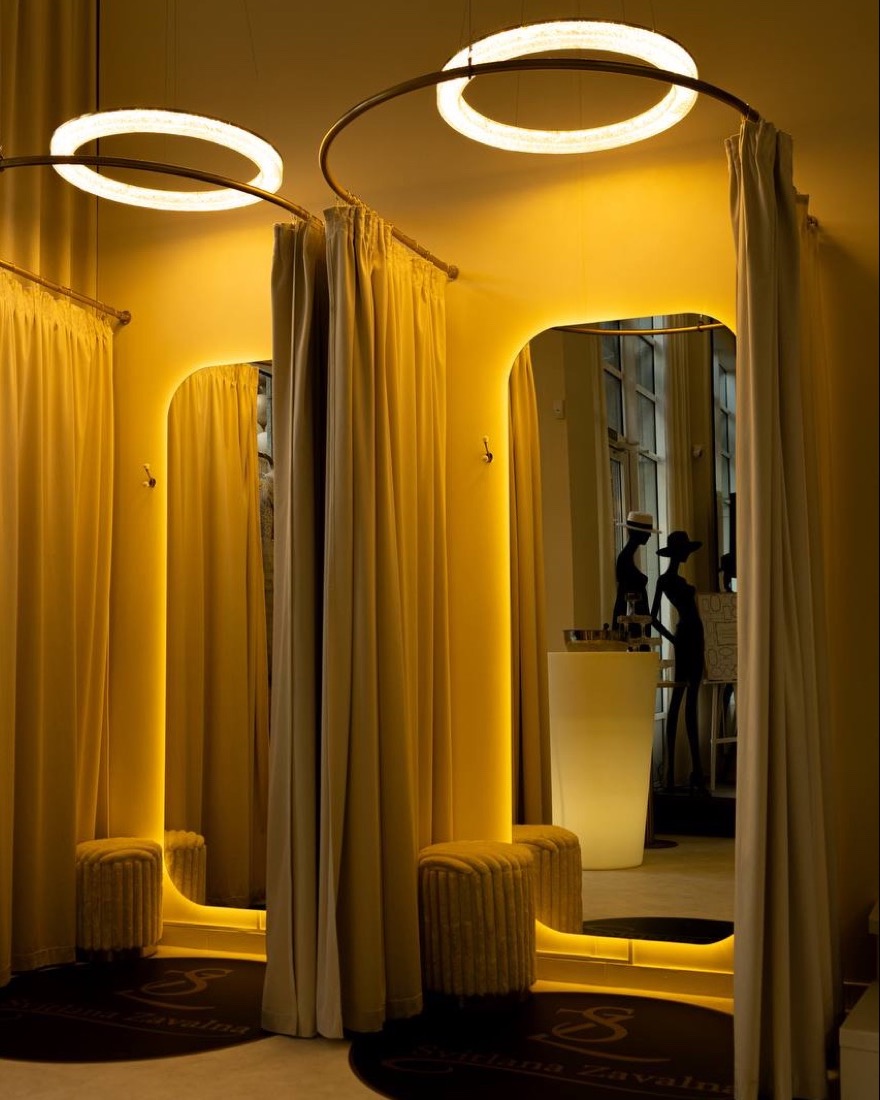 Fitting room with warm light and arched mirror